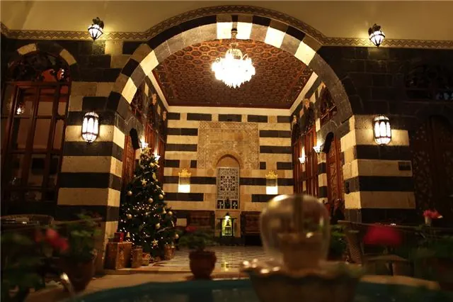 A view through the stone arch to the courtyard fountain